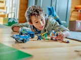 Child playing with LEGO police dog set.
