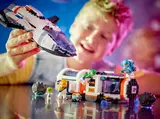 Child with spaceship module and minifigs.