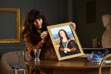 Woman admiring LEGO Mona Lisa.