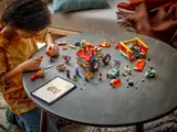 Child building Monkie Kid's Team Power Truck with digital instructions.