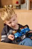 Child examining ice-themed Grave Digger.