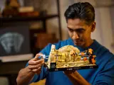 Person holding the diorama, close-up on Anakin's pod.