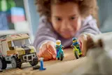 Child playing with LEGO minifigures.