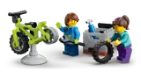 Minifigures fixing a bike.