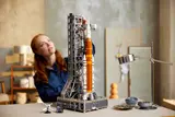 Woman looking at LEGO rocket.