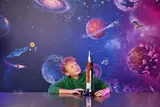 Boy marveling at LEGO Artemis rocket.
