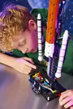 Child interacts with rocket launch mechanism.