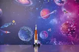 LEGO Artemis rocket on display with space background.