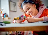 Child holding LEGO Camaro ZL1.