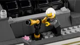 Professor using telescope on rooftop.