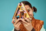 Girl holding open LEGO Glamping Cabin.