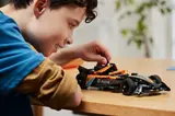Child playing with McLaren Formula E car.