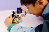 Interacting with the LEGO Minecraft End portal's action feature.