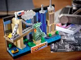 LEGO New York Postcard set on a wooden desk with office items.