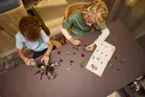 Overhead view of children building LEGO DREAMZzz 71513.