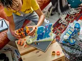 Builder assembling the LEGO basketball.