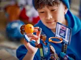 Child holding LEGO basketball.