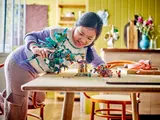 Child playing with Monkie Kid dragon