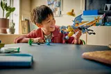 Child playing with LEGO Riyu dragon and minifigures.