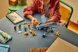 Overhead view of a child building the LEGO Riyu dragon.