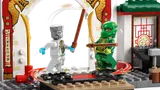 Zane and Lloyd minifigures sparring on spinning platforms.