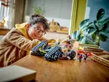 Child playing with Ninjago vehicle.