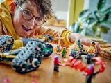 Child playing with separated Ninjago vehicles.