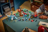 Child playing with LEGO Ninjago set, digital instructions nearby.
