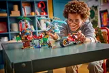 Smiling child playing dynamically with LEGO Ninjago vehicles.