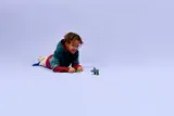 Child playing with green LEGO monster.