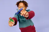 Child holding Nya spinner and monster.