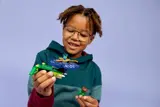 Child smiling with Nya spinner and monster.