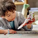 Child playing with starfighter on carpet.