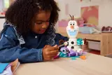 Child playing with Olaf and Bruni