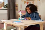 Child smiling with Olaf and Bruni