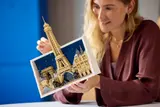 Woman holding LEGO Paris model.