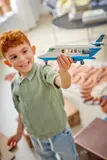 Child proudly holding jet