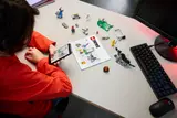 Child building with digital instructions.