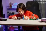 Child playing with Fortnite LEGO.
