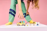 Girl setting up LEGO Pet Van scene.
