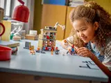 Girl playing with Spider-Man's Apartment.
