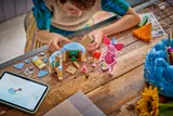 Child building with digital instructions.