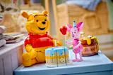 Piglet, cake, and Winnie the Pooh together.