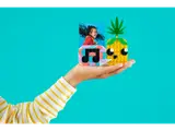 Hand holding LEGO DOTS pineapple build.