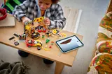 Child playing with LEGO pizza set.
