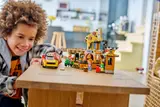 Child playing with LEGO car.