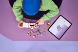 Child building LEGO truck.
