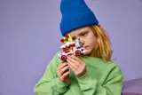 Child holding pizza truck.