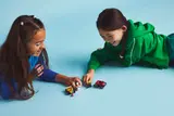 Kids engaging with minifigures.