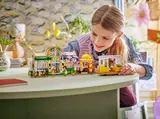 Child playing with LEGO botanical set.